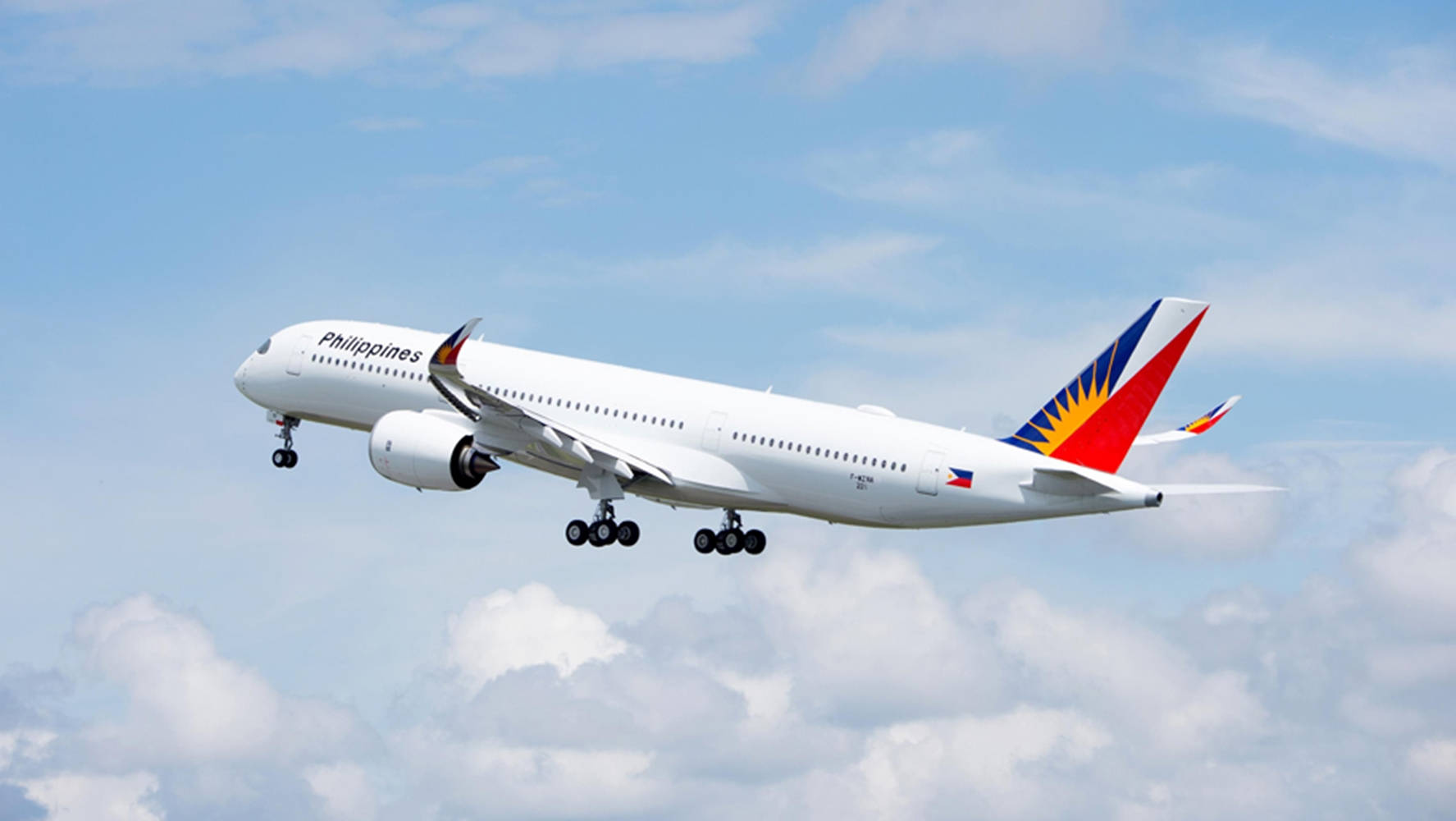 Philippine Airlines Airplane In Cloudy Bright Skies Background