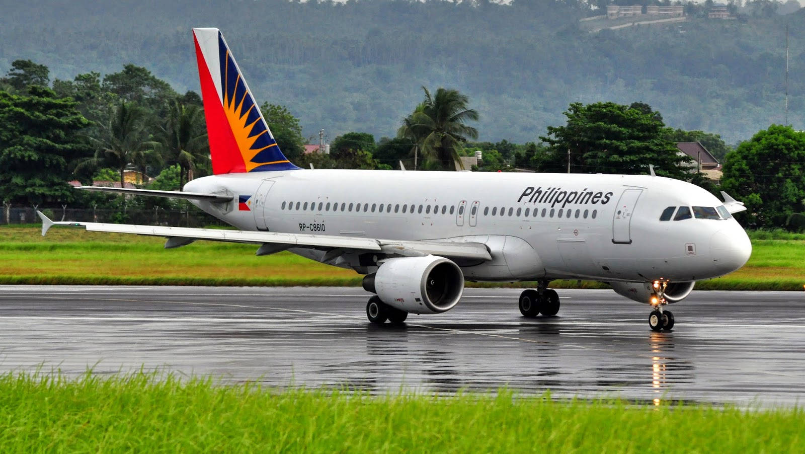 Philippine Airlines Airplane On Wet Runway Background