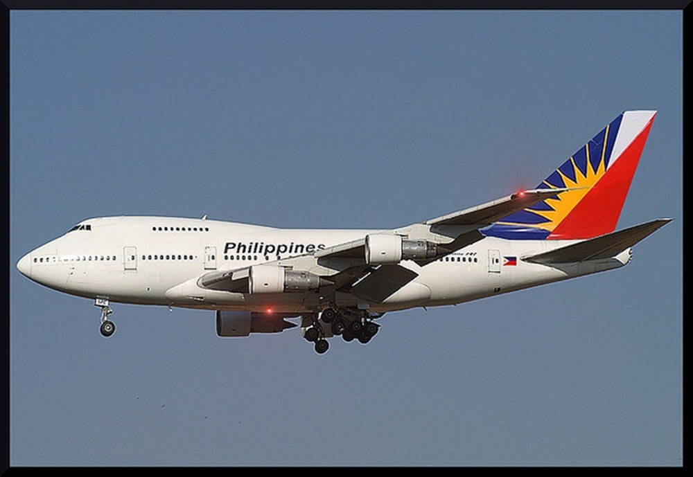 Philippine Airlines Flying Airplane In Dark Sky Background