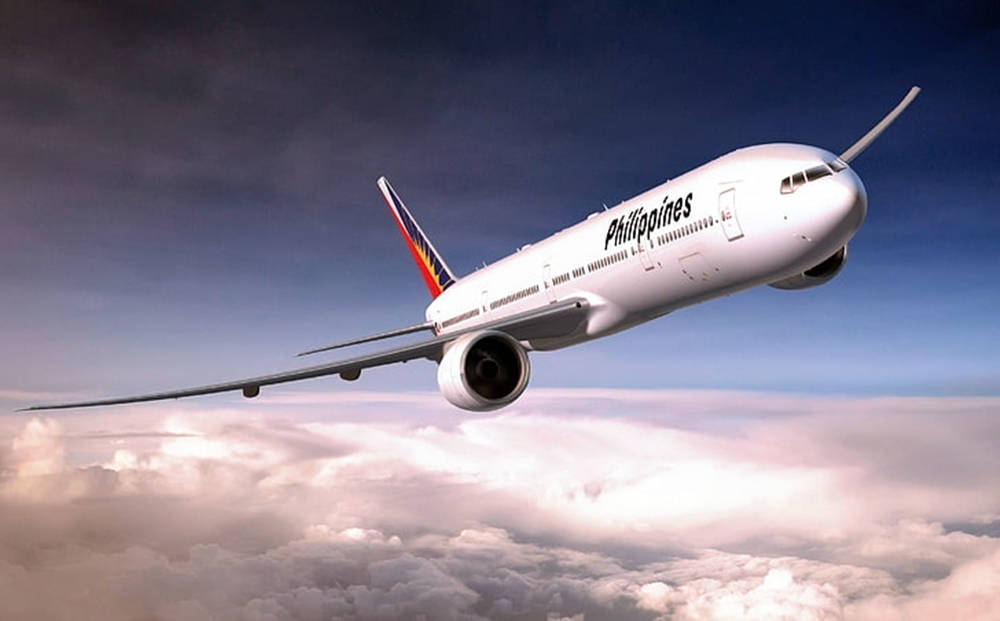 Philippine Airlines Gliding Above Clouds Background