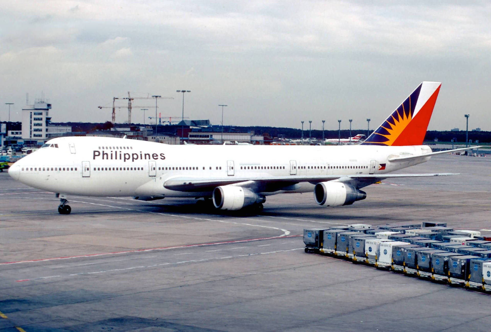 Philippine Airlines On Airport Runway With Cargo Background