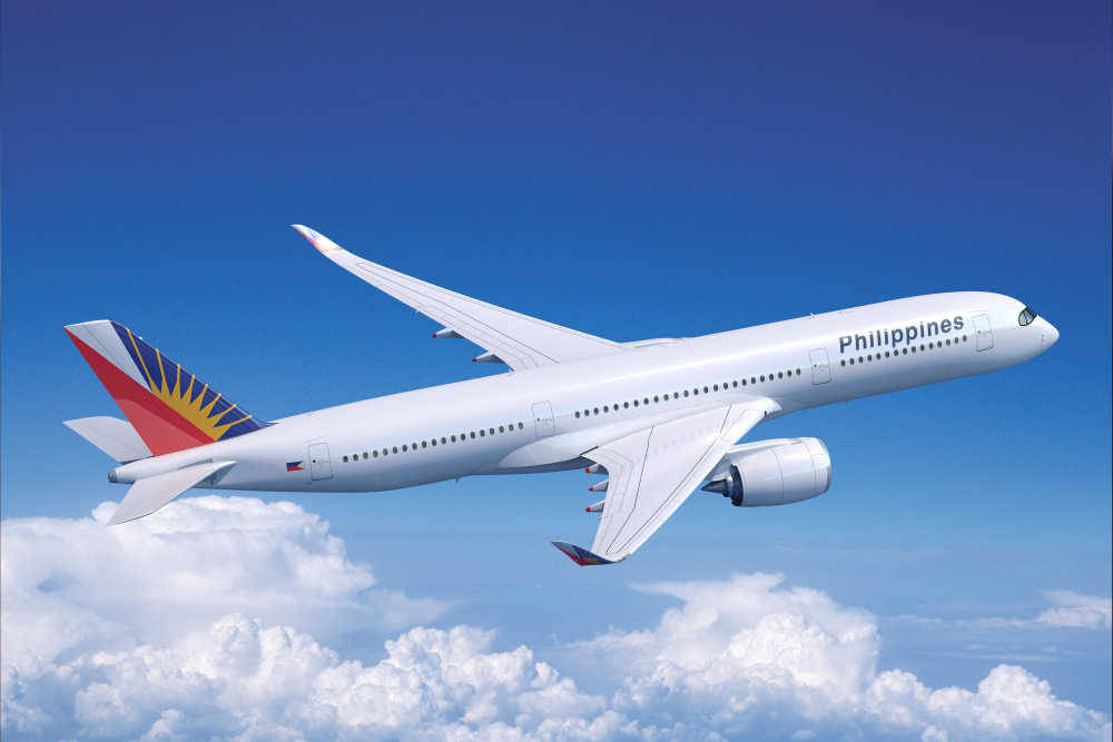 Philippine Airlines Plane Flying Above Clouds Background