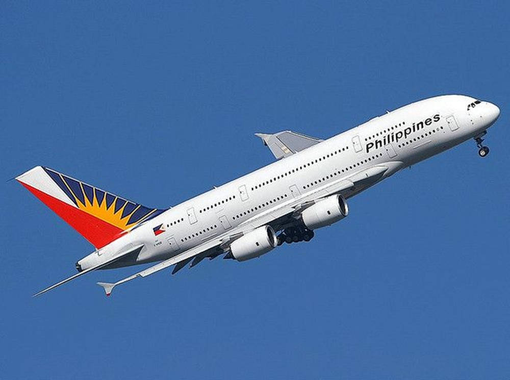 Philippine Airlines Plane In Clear Blue Sky Background