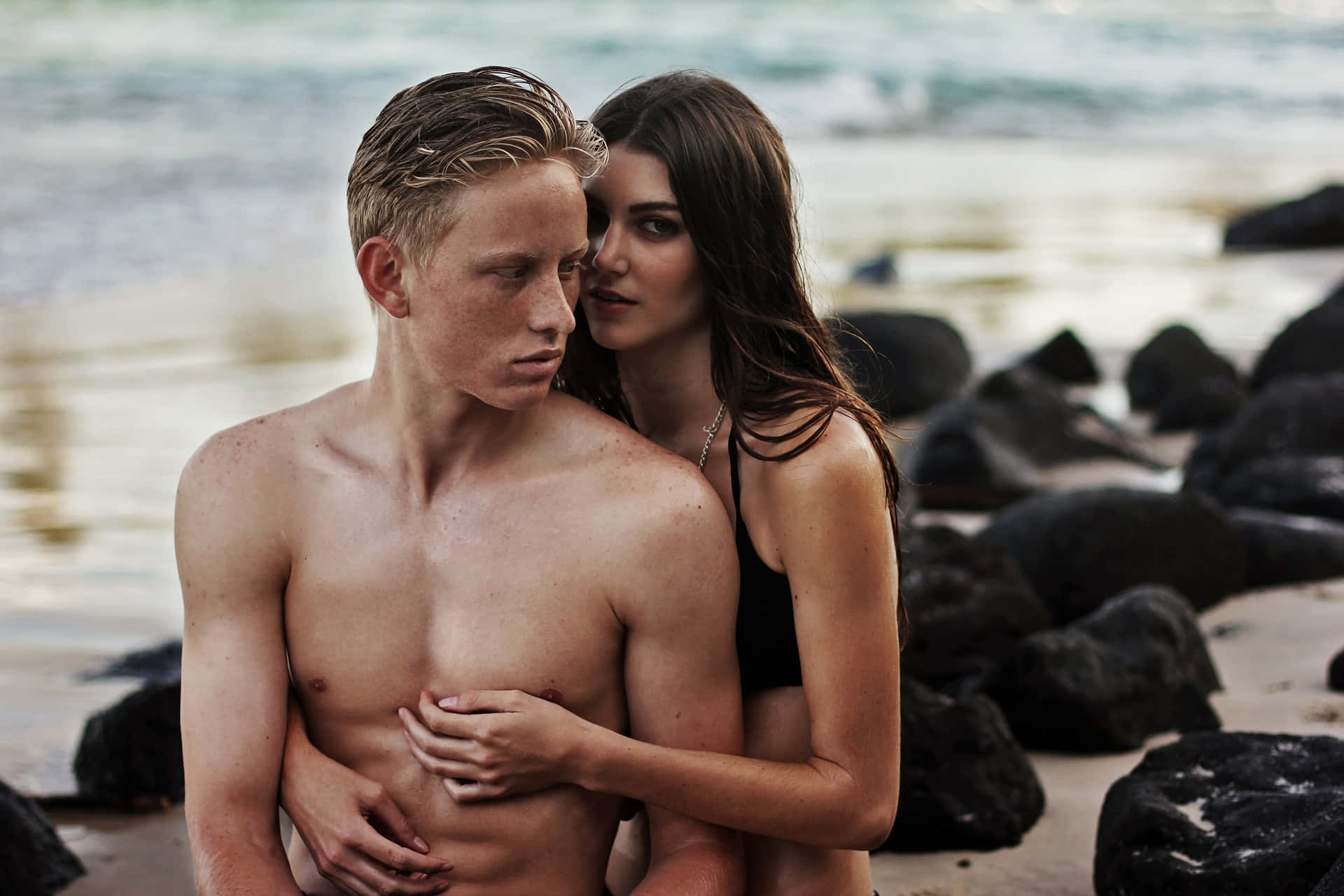 Photo Of A Couple Representing A Tangible Love On The Beach Background