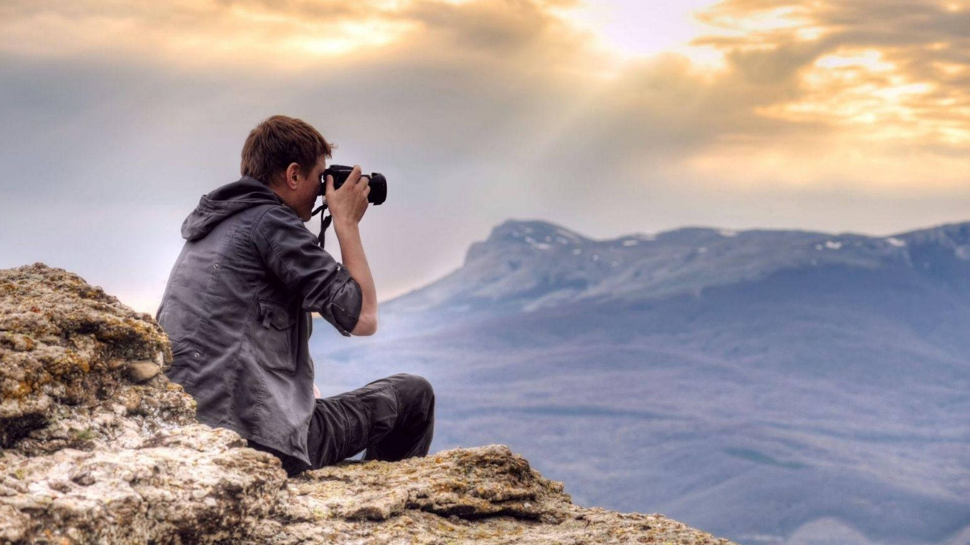 Photographer On A Mountain Background