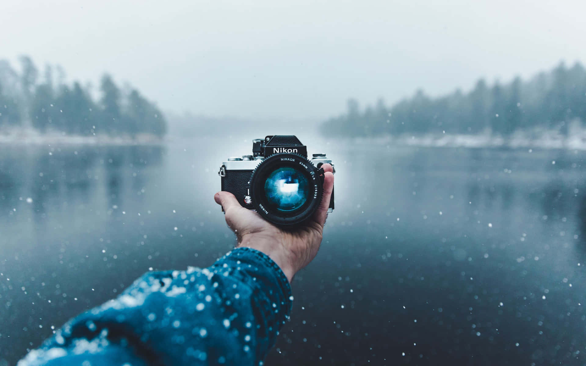 Photography Camera In Ocean With Snow Background
