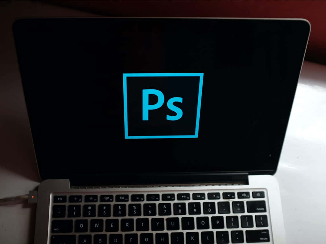 Photoshop Logo On A Laptop Screen Background