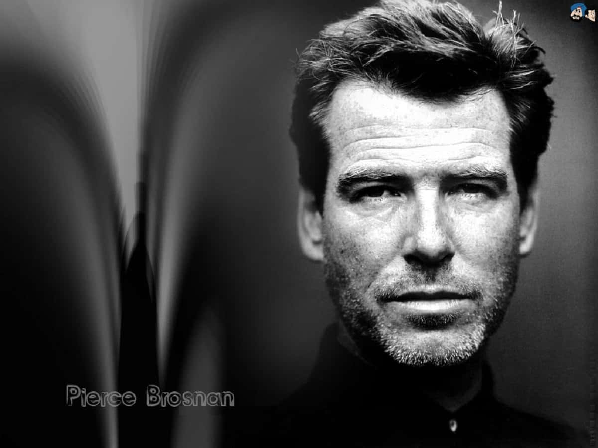 Pierce Brosnan Looking Suave In A Black Tuxedo. Background