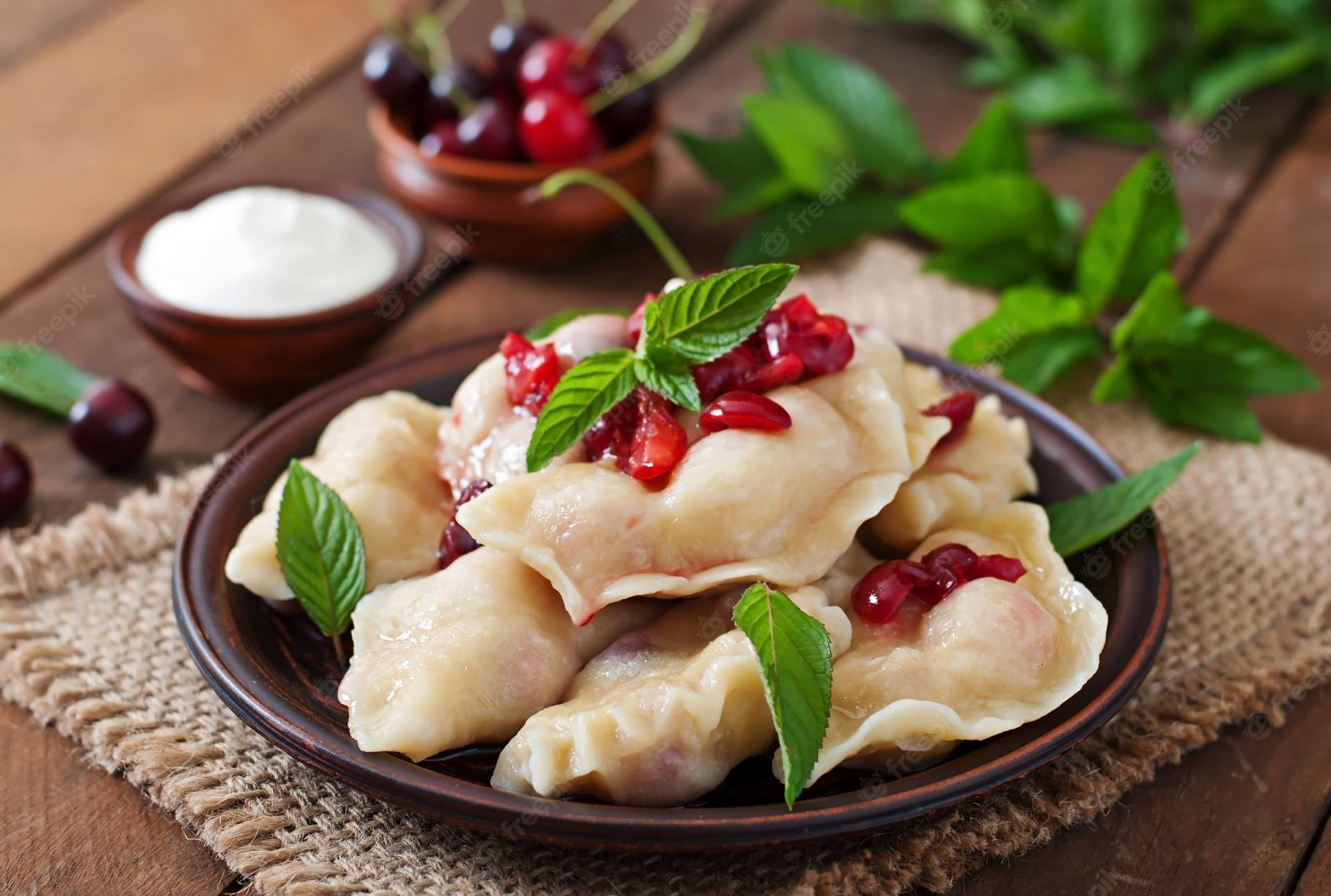 Pierogi And Red Cherries Background