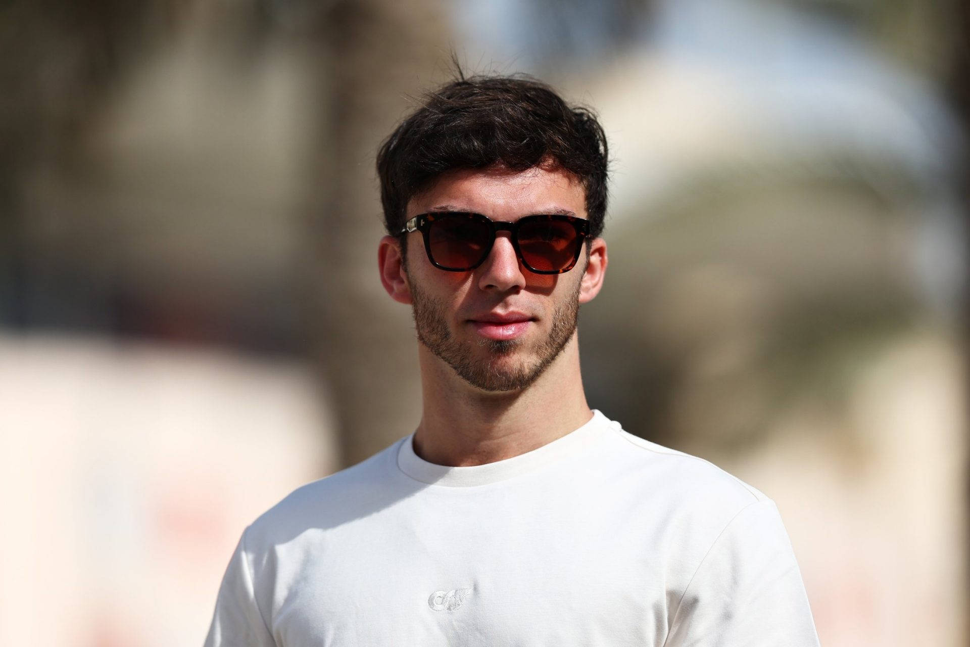 Pierre Gasly Exuding Confidence In Simple White Shirt. Background