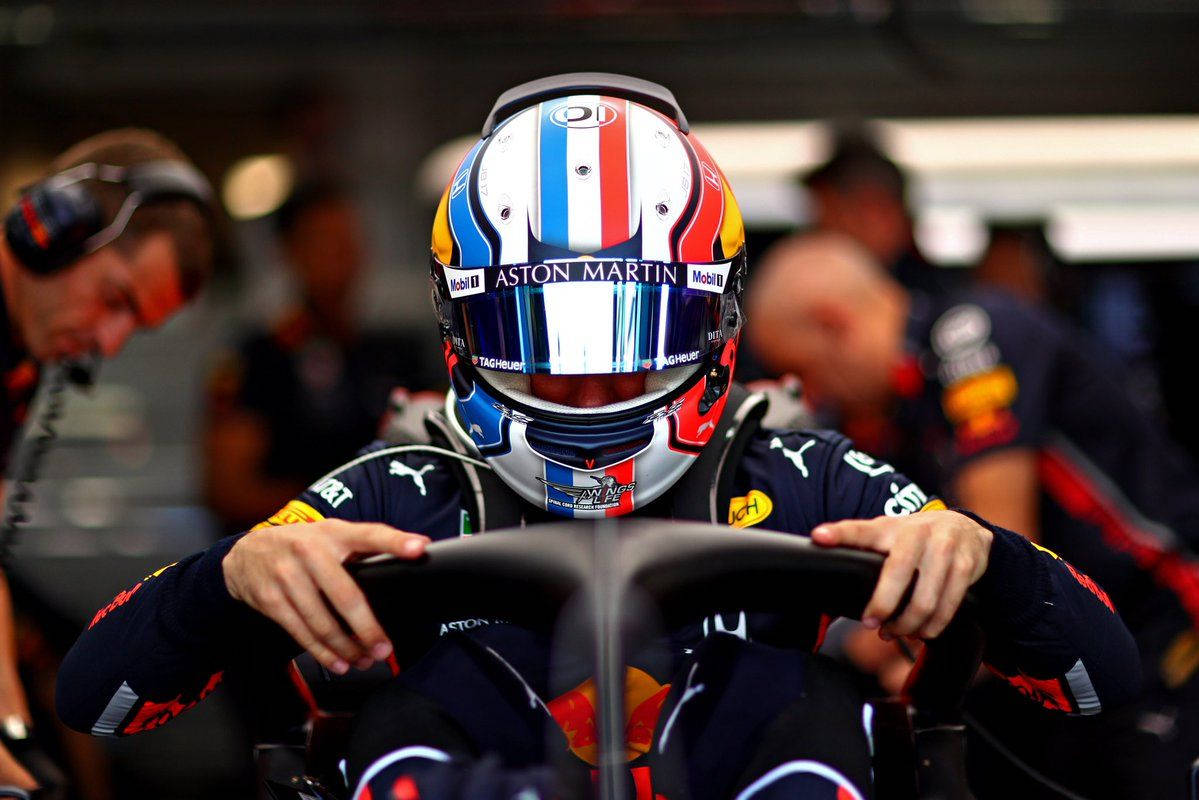 Pierre Gasly Gripping The Halo Of His Race Car Background