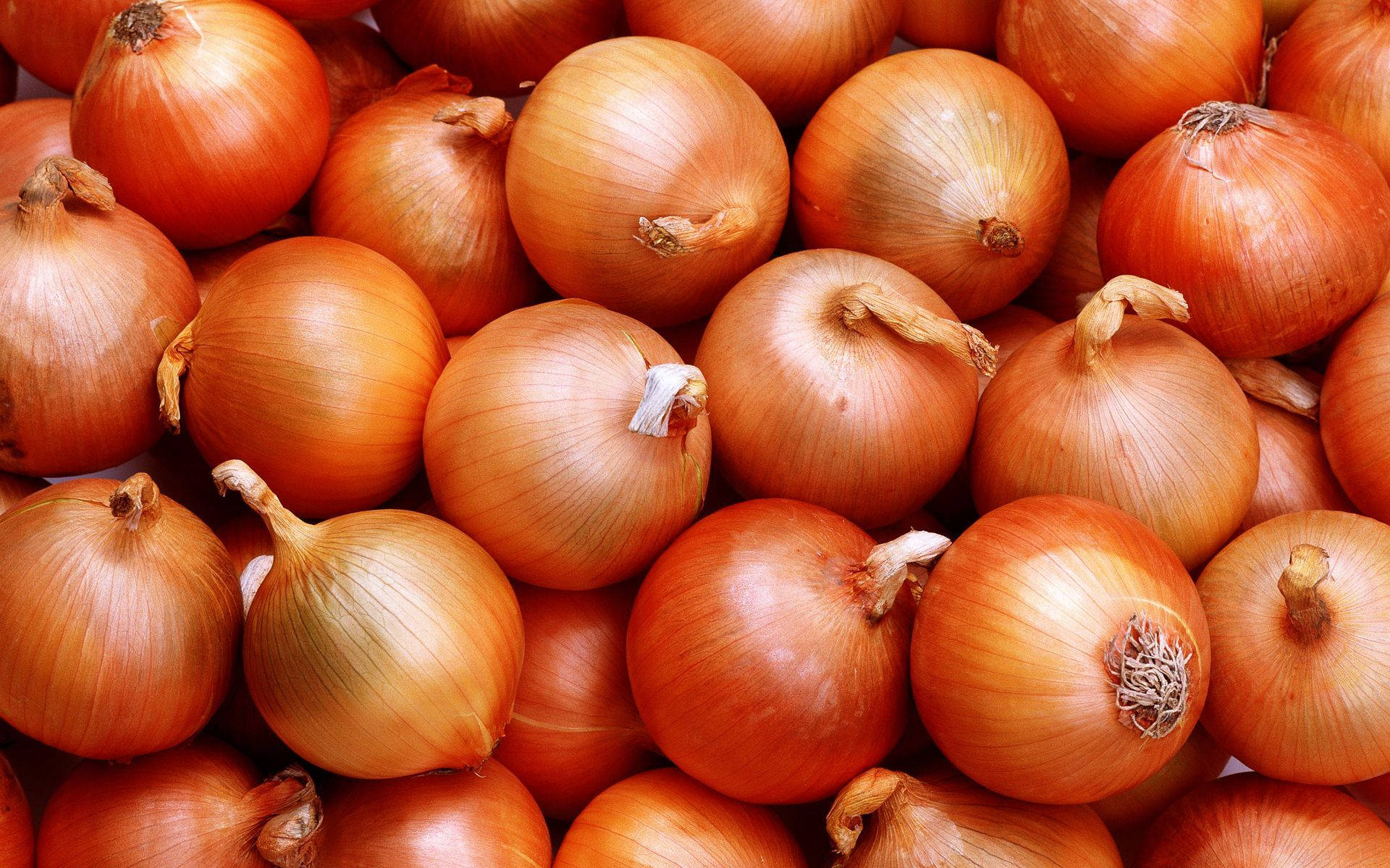 Pile Of Onions With Orange Skin Background