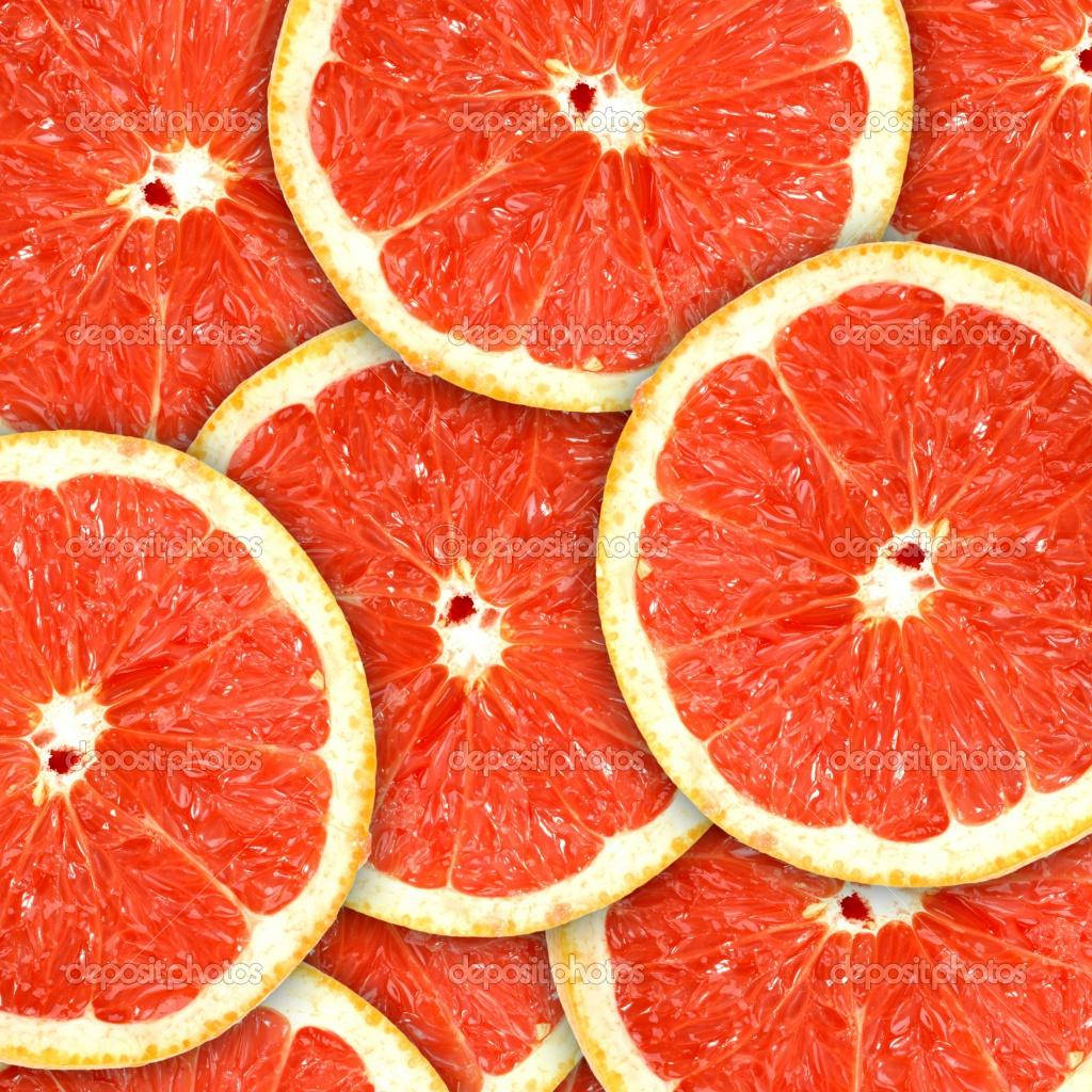 Pile Of Sliced Tropical Grapefruits Background