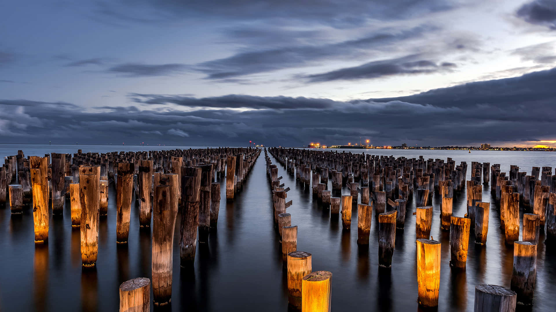 Piled Poles Away From The Shore Background