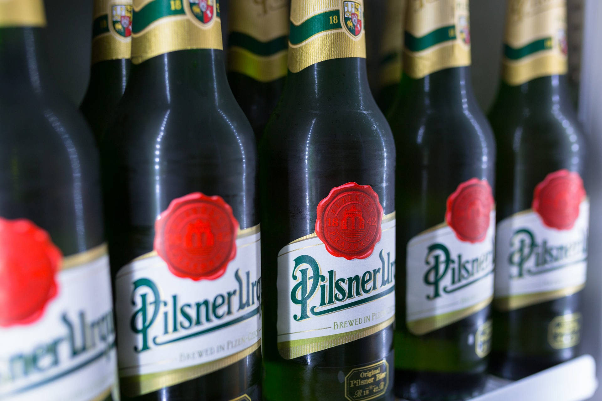 Pilsner Urquell Bottles Background