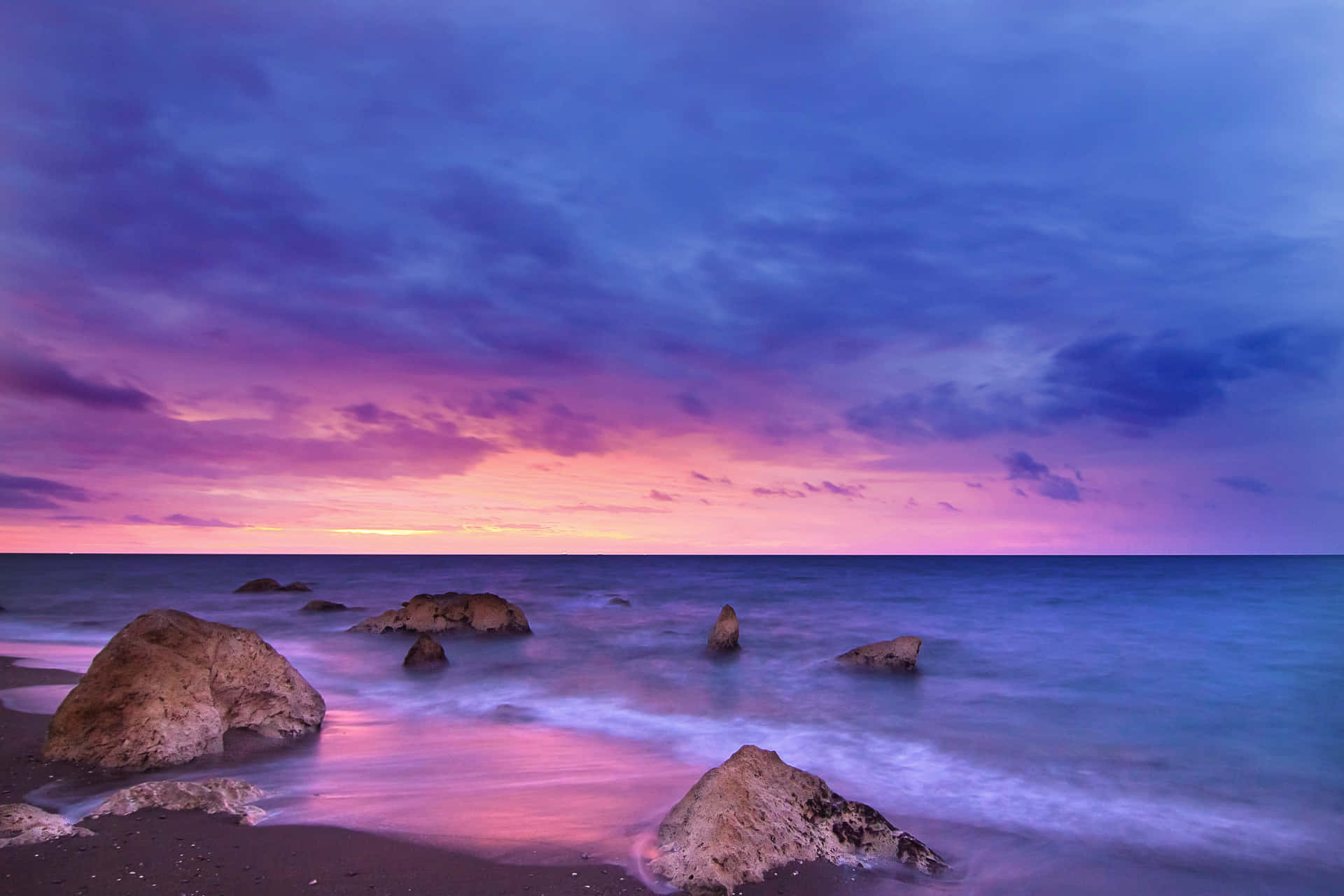 Pink Beach Sunset With Purple Waters Background