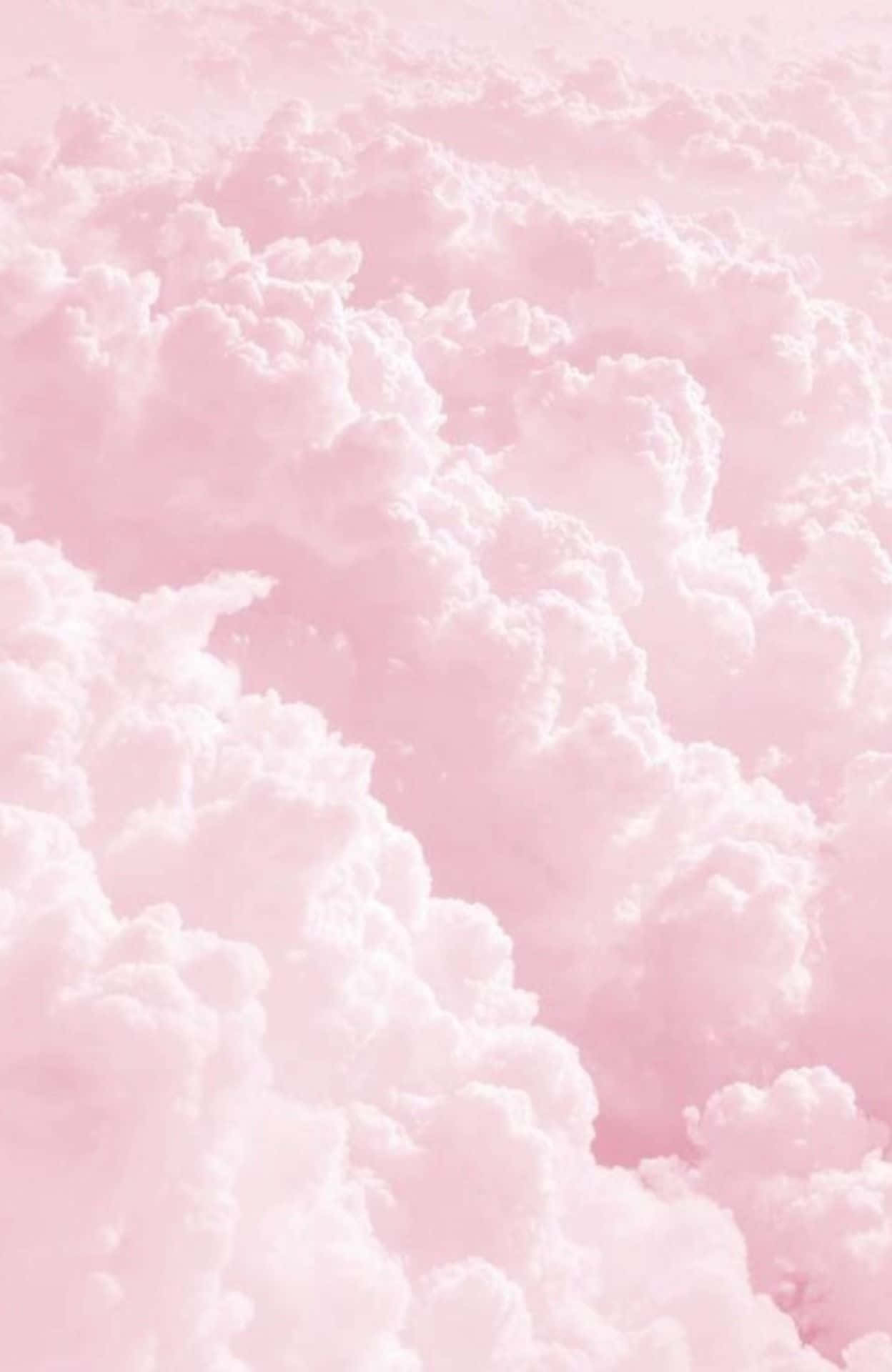 Pink Clouds In The Sky With A Pink Background Background