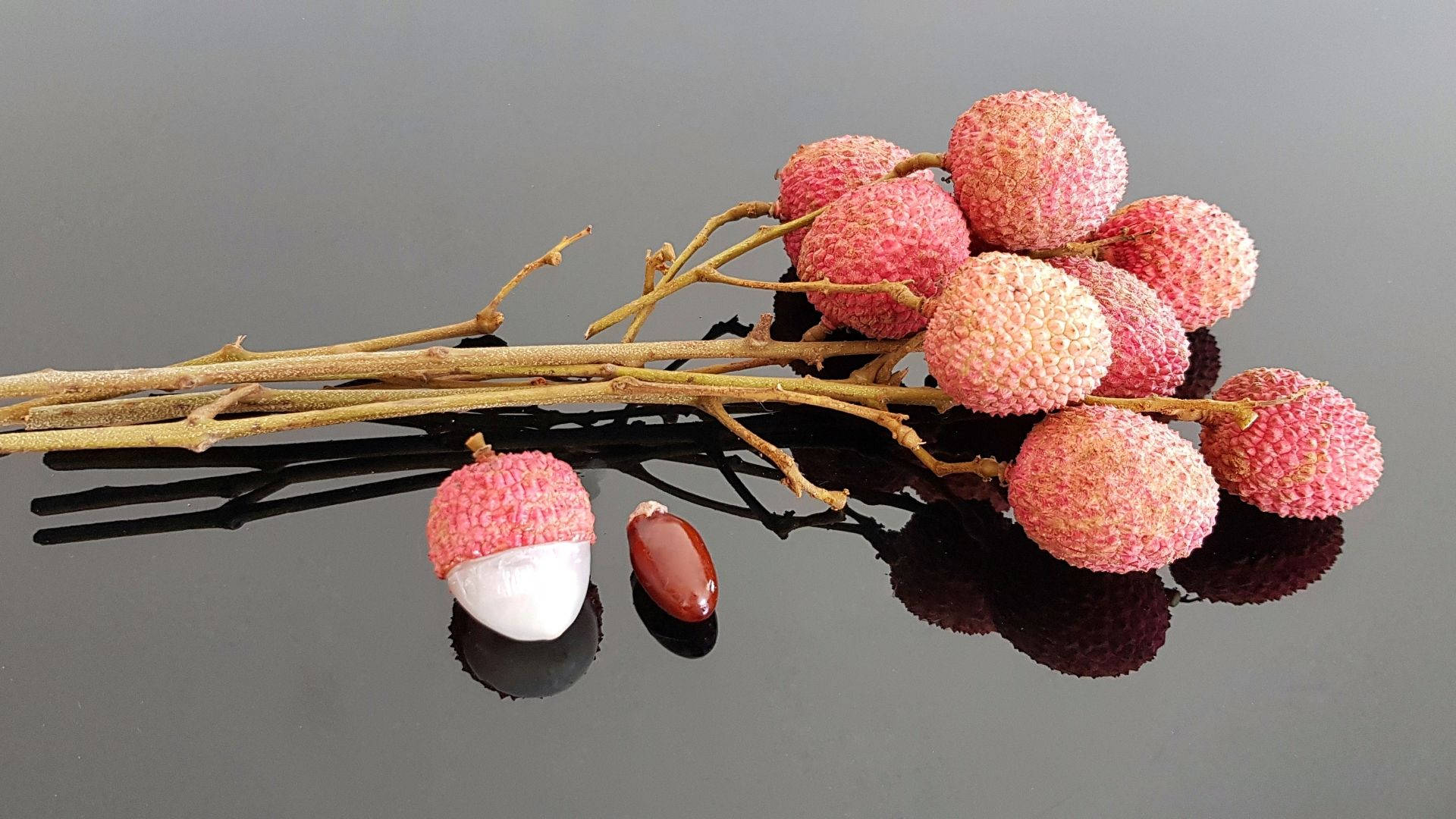 Pink Lychee Fruits Attached To Twigs