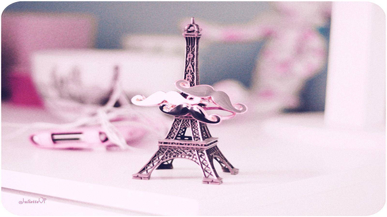 Pink Paris Eiffel Tower Ornament On Desk Background