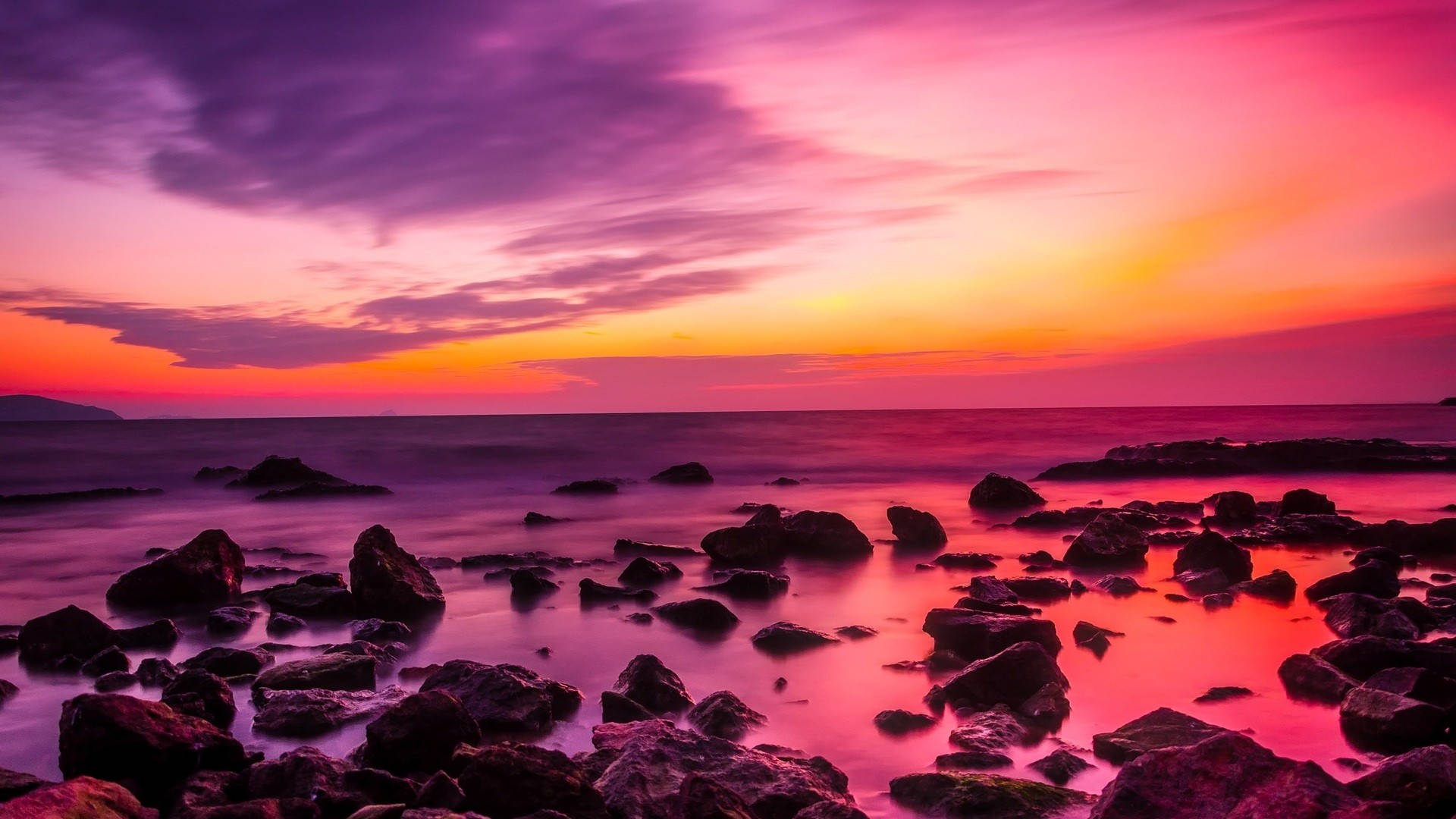 Pink Sunset On Rocky Beach Background