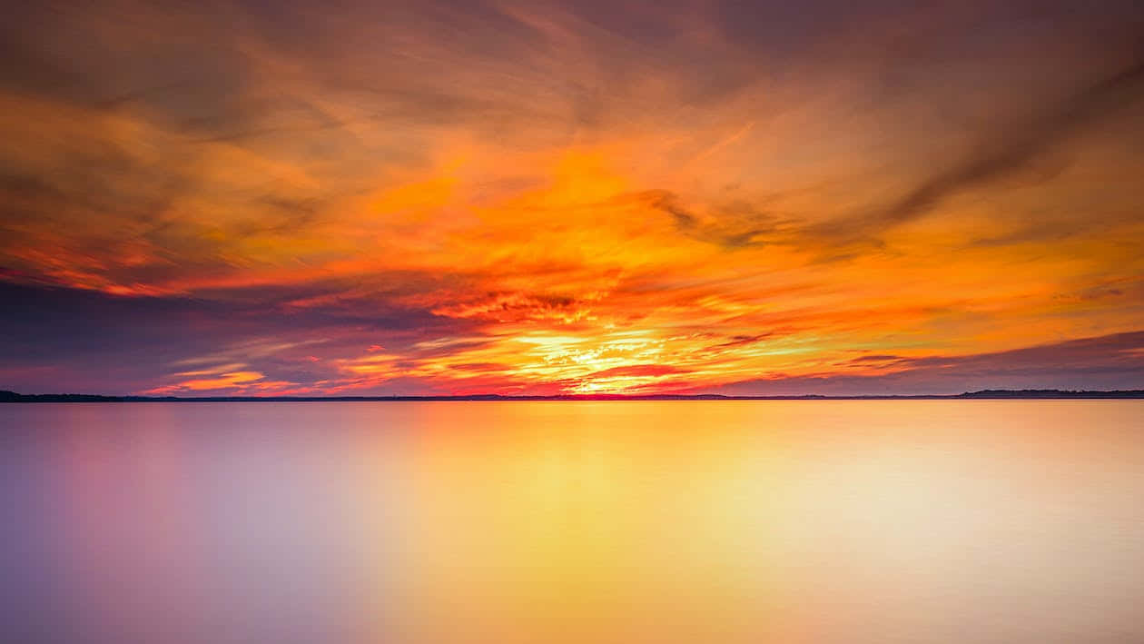 Placid Ocean On A Sunset Background