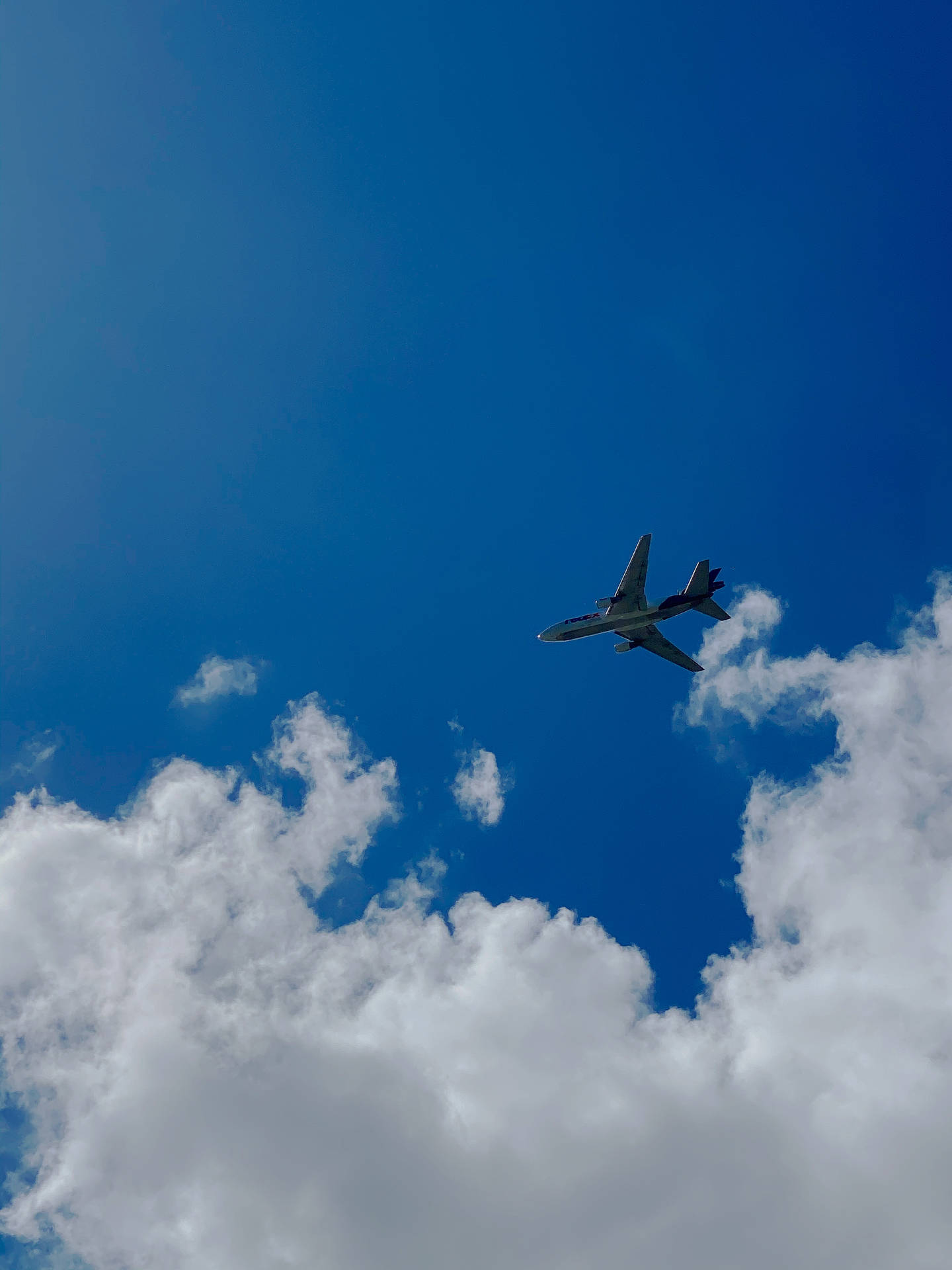 Plane Flying Under Azure Sky Background