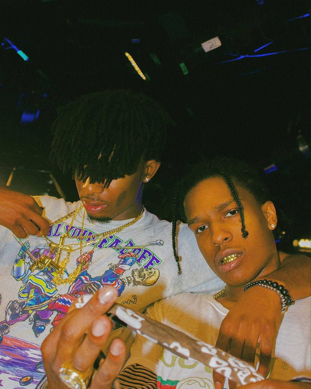 Playboi Carti And A$ap Rocky Standing Side-by-side Background