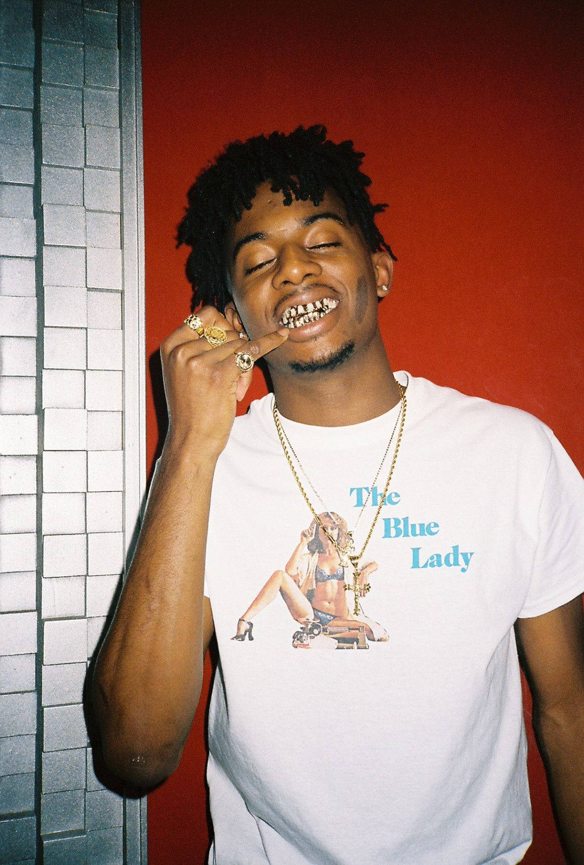Playboi Carti Gives A Wide Smile For His Fans Background