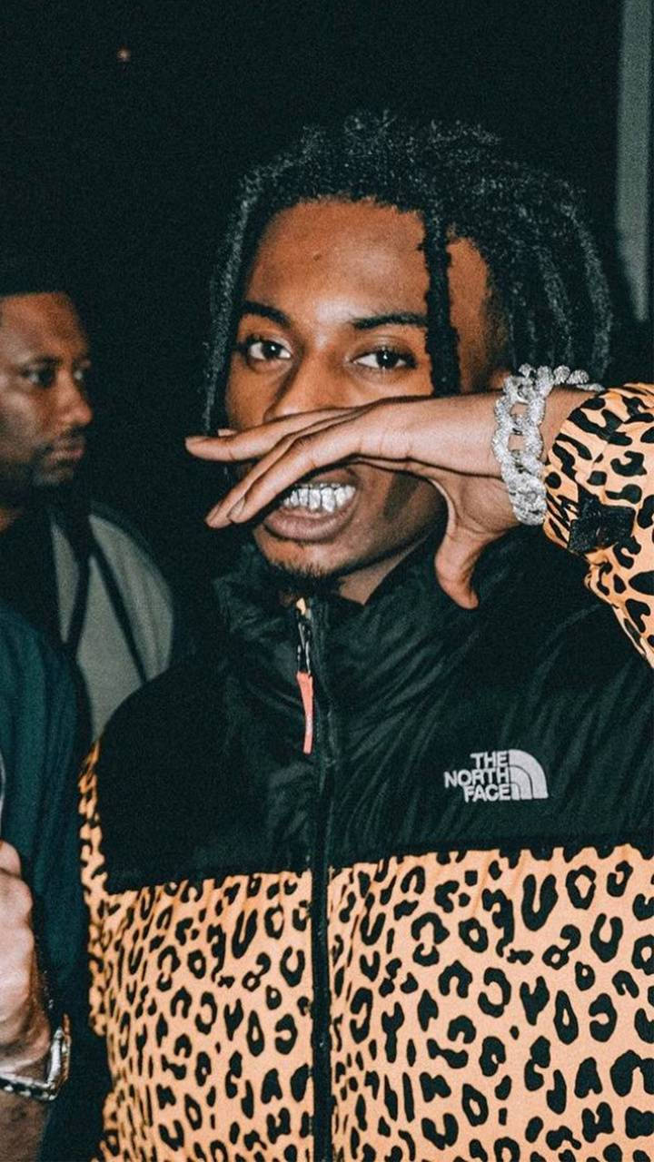 Playboi Carti Poses In A Leopard Graphic Print Background