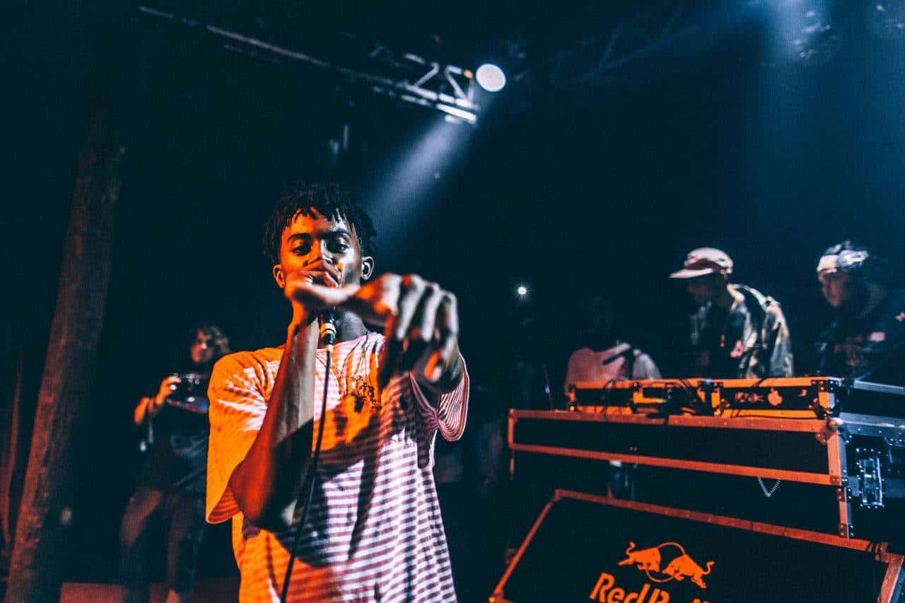Playboi Carti Poses In His Iconic Blue And Pink Pc Music Visuals Background
