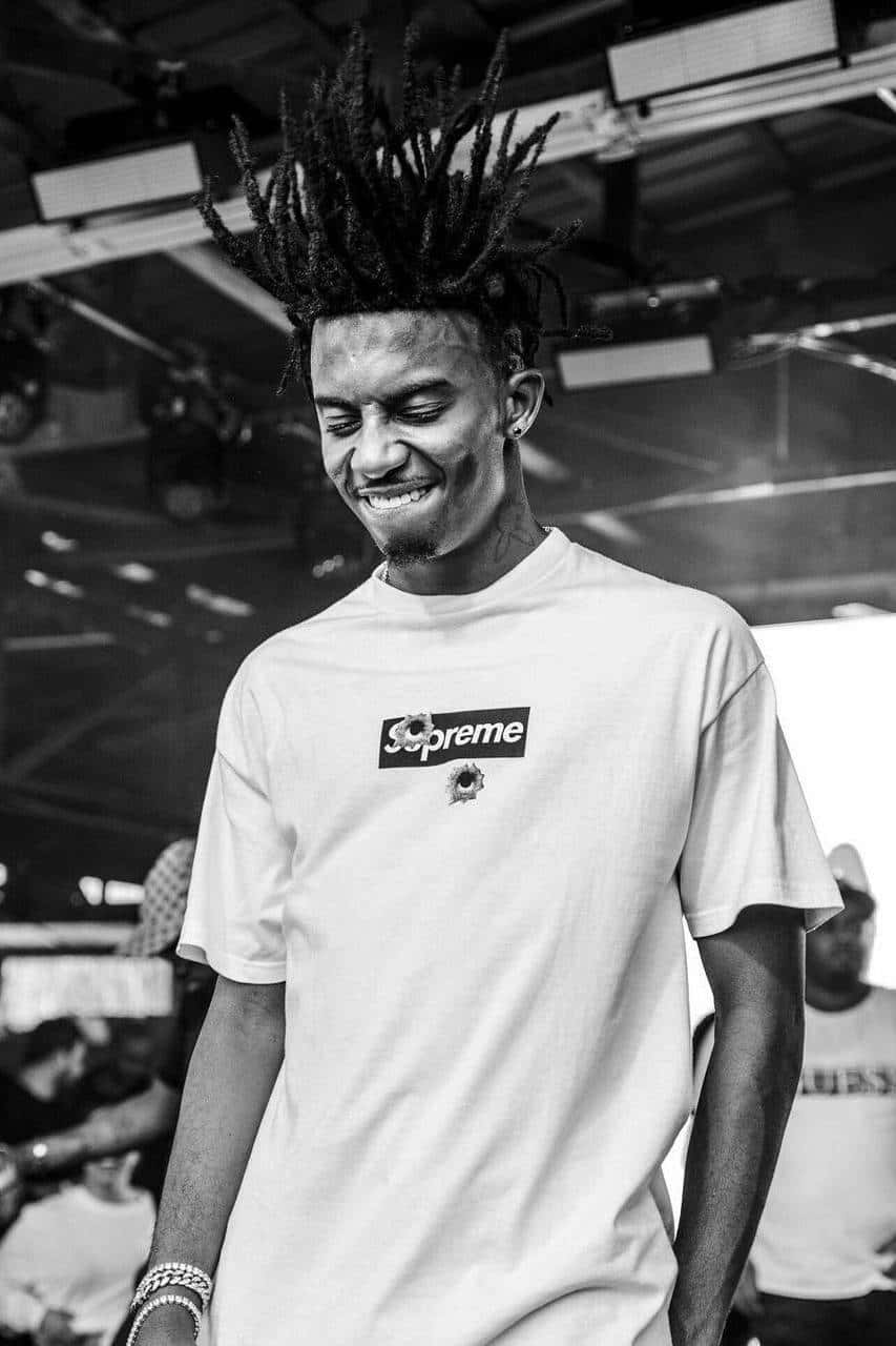 Playboi Carti Stands Atop His Newly Released Album 'playboi Carti: Pc' Background