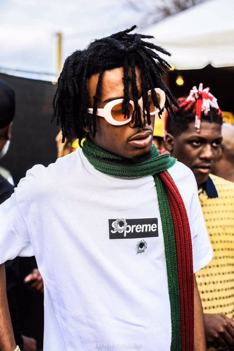 Playboi Carti Styling In His Supreme Shirt Background