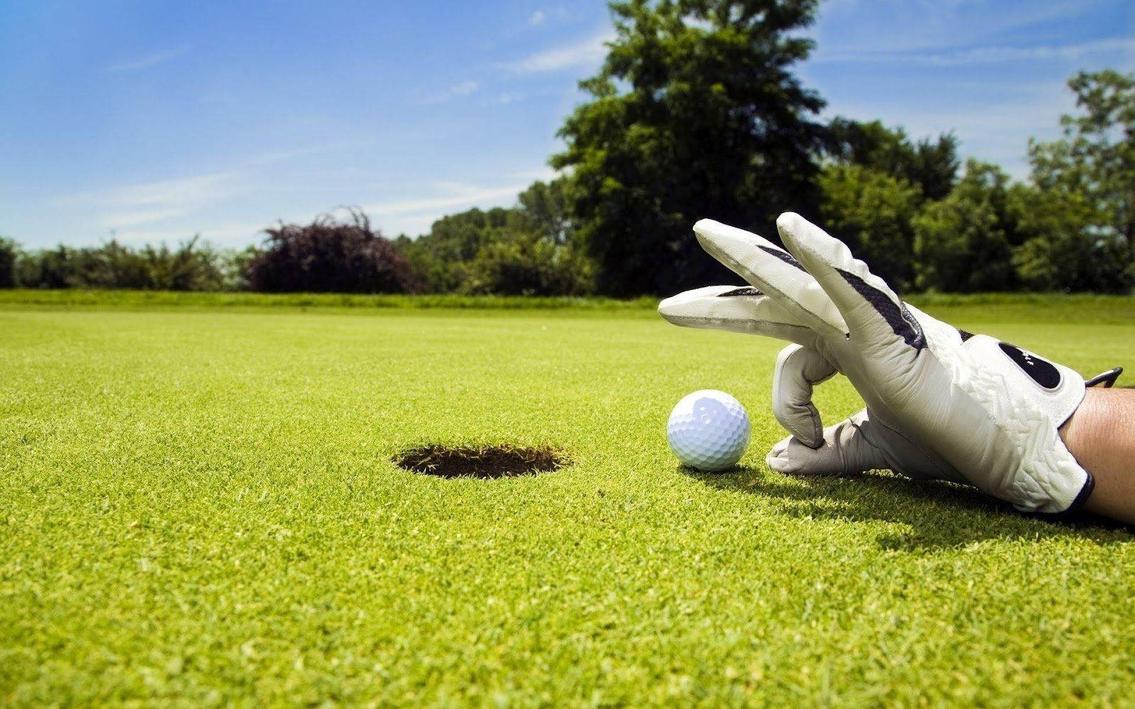 Player Interacting With A Stylish Golf Ball Background