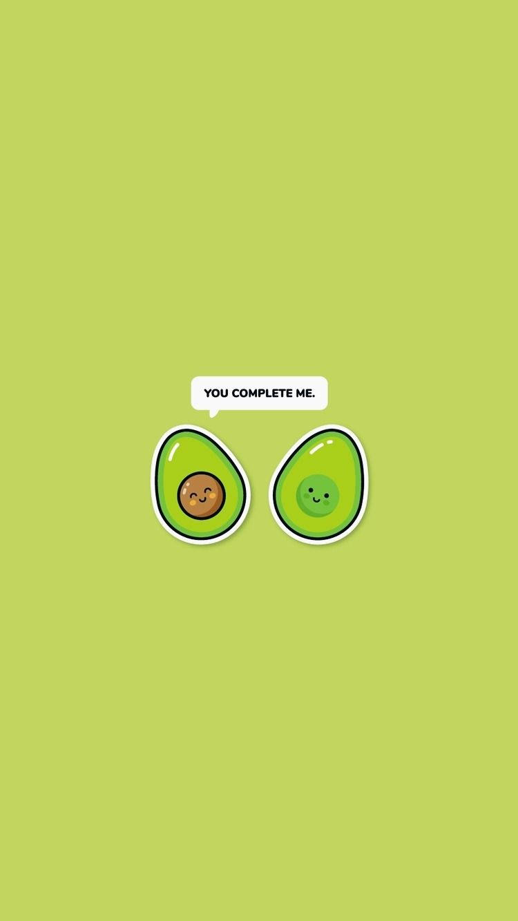 Playful Banter Between Two Adorable Avocados Background