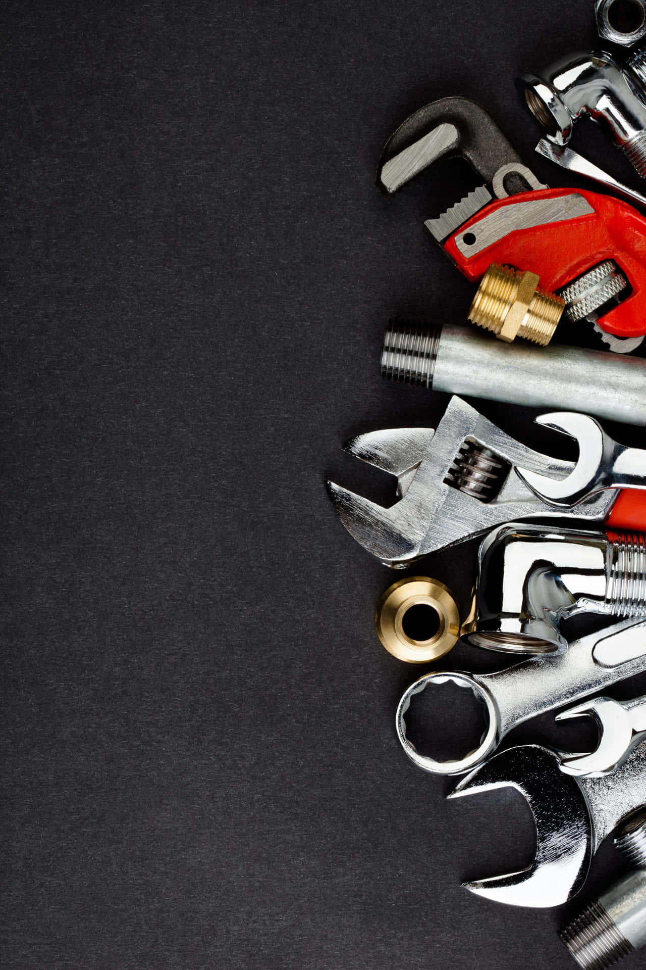 Plumbing Tools On Textured Black Background