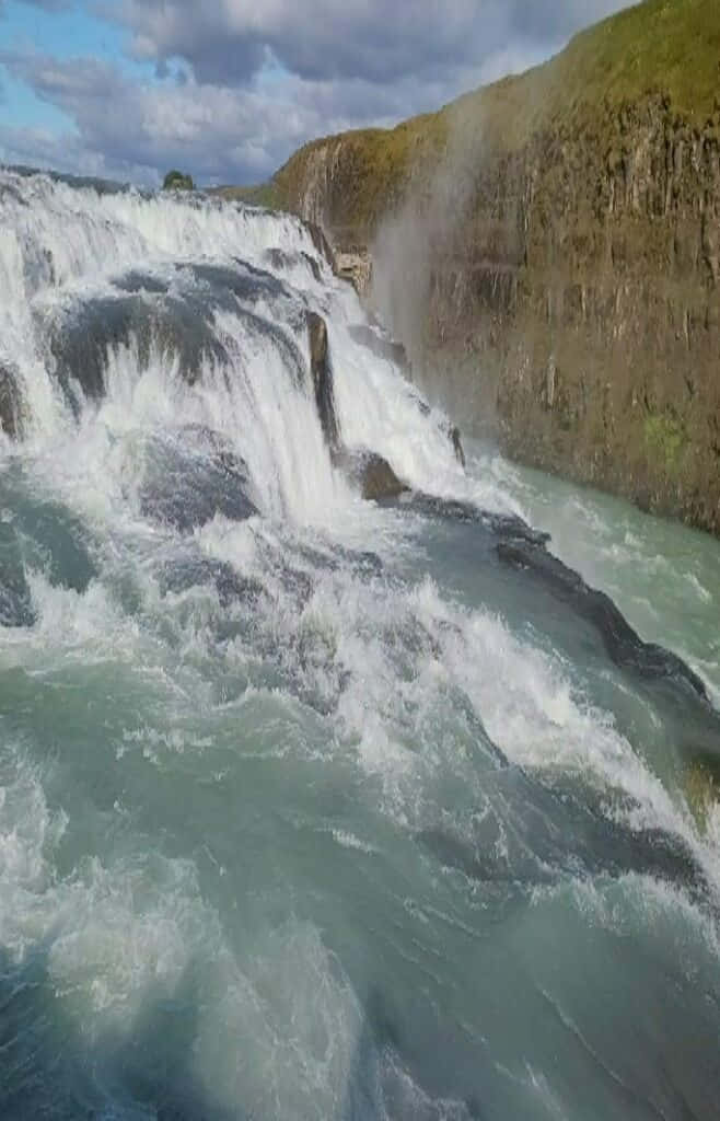 Plunging Gullfoss Waterfall In Southwest Iceland Background