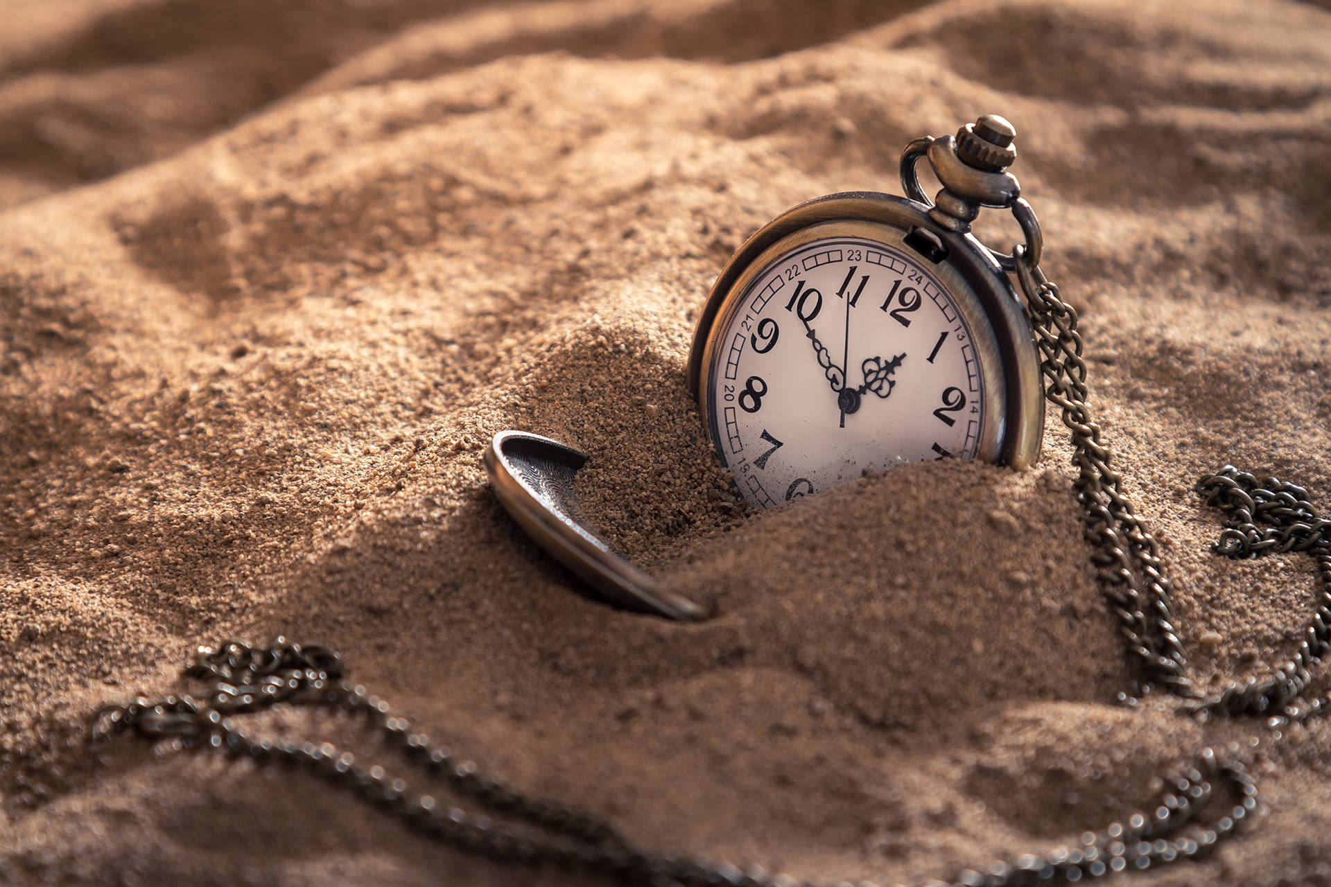 Pocket Watch On Sand Background