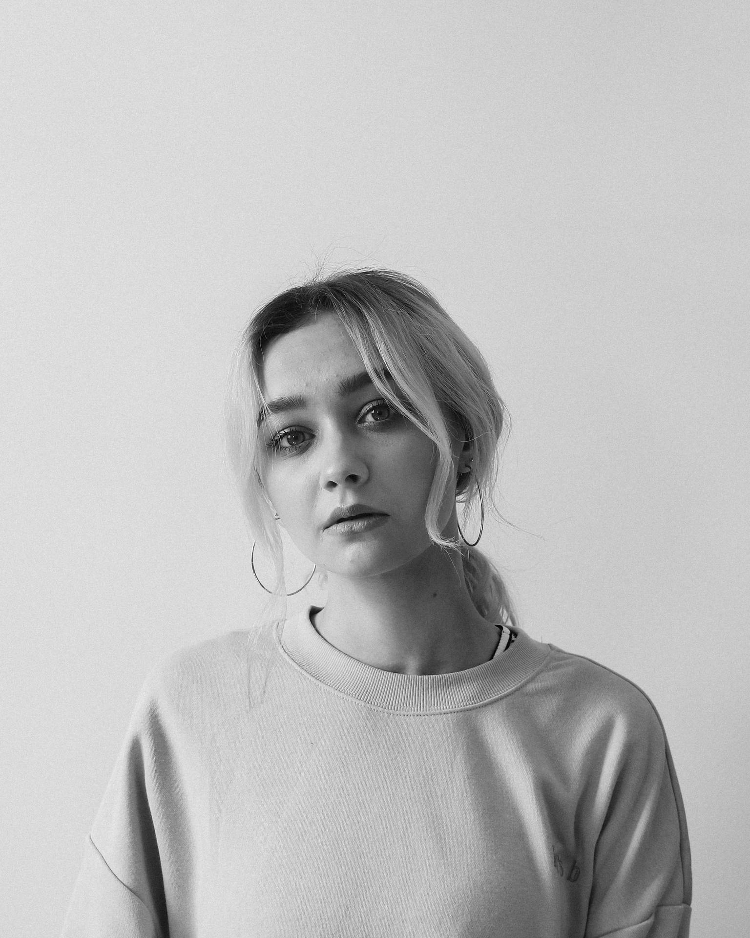 Poised Elegance – A Black And White Portrait Of A Young Woman Background