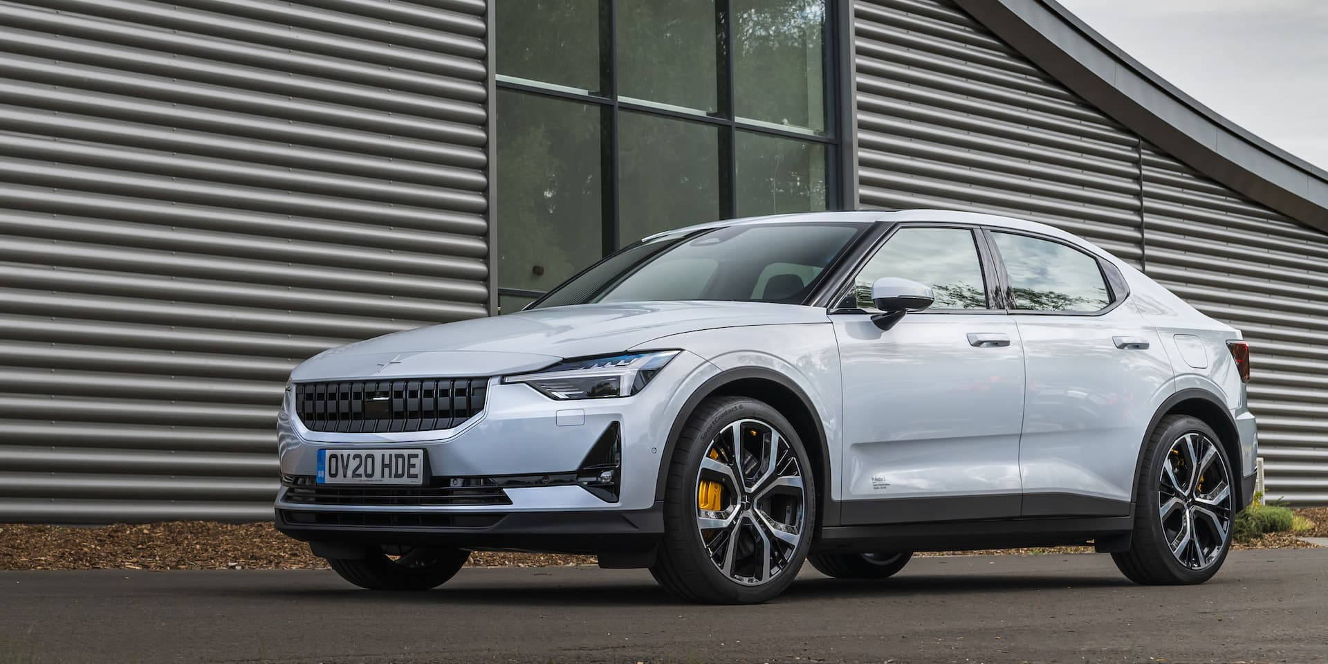 Polestar 2 Parked By A Modern Home Background