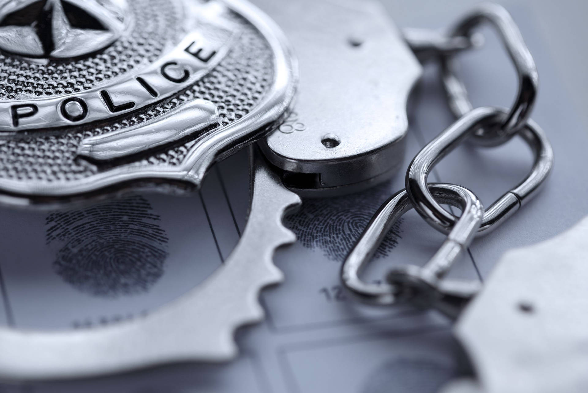 Police Officer Badge And Steel Handcuff Background