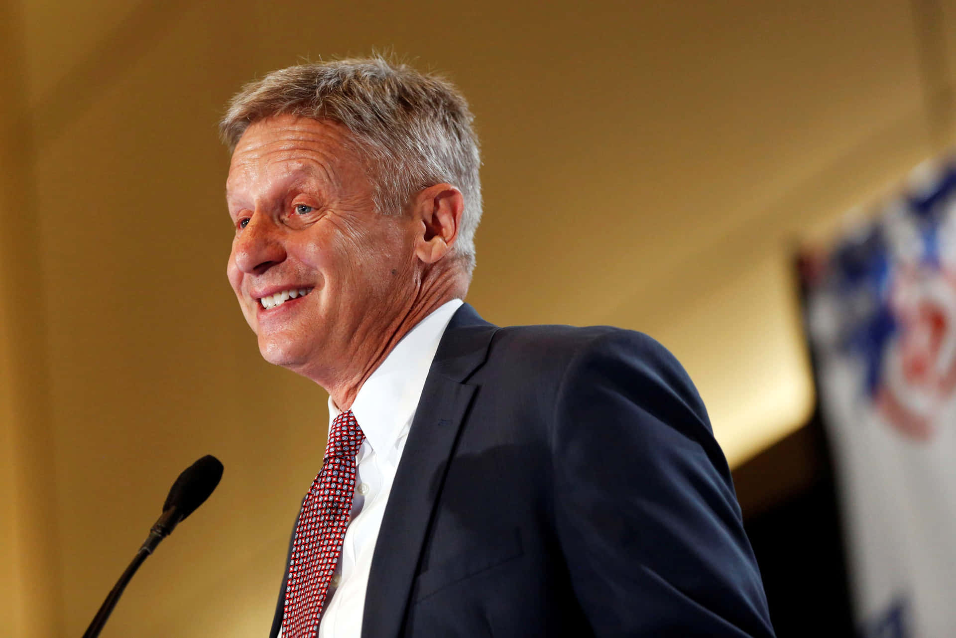 Politician Gary Johnson Smiling With Yellow Back Drop Background