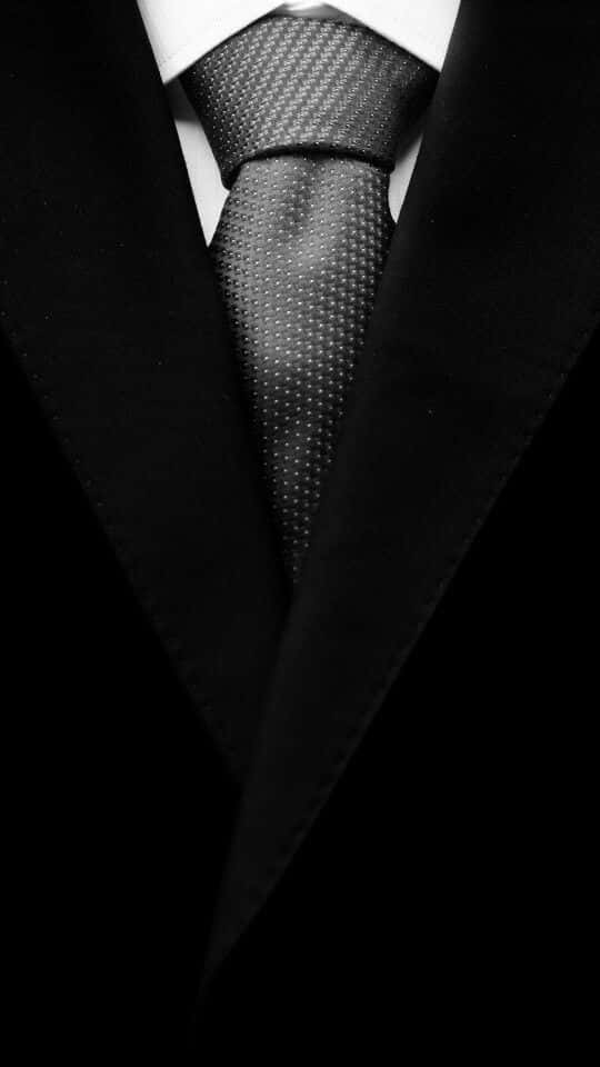 Polka Dots Necktie With A Black And White Men Suit Background