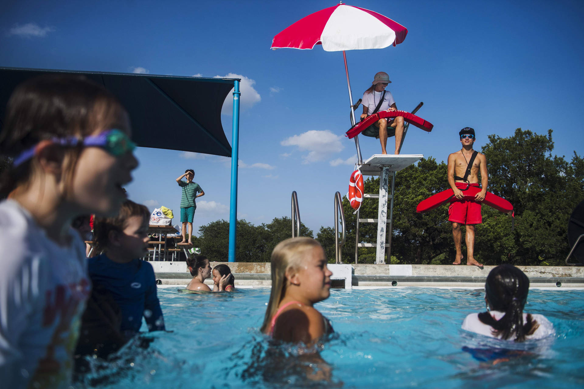 Pool Lifeguard Watching Over Kiddie Pool Background