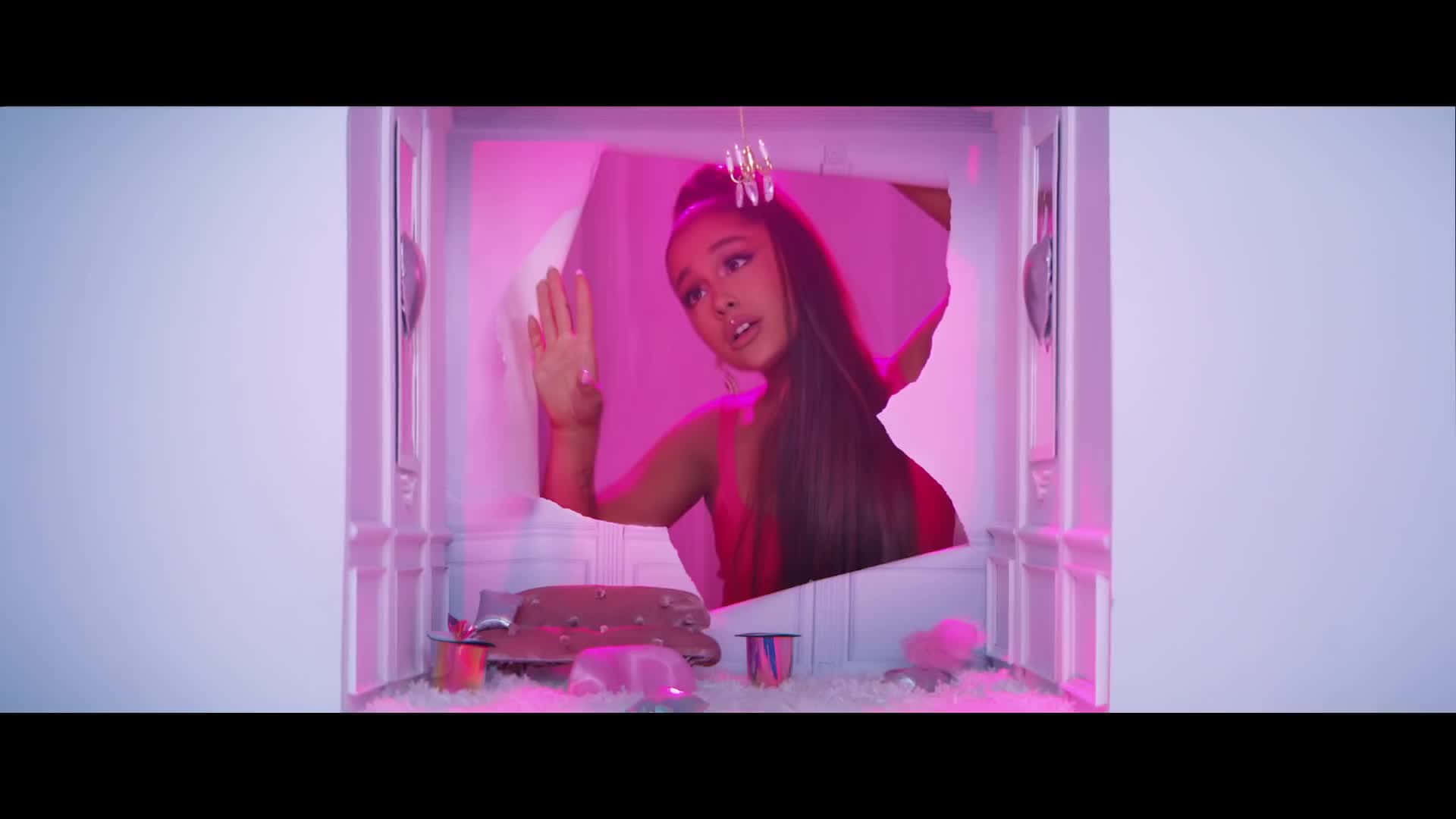 Pop Star Ariana Grande Showcasing Her Iconic 7 Rings Background