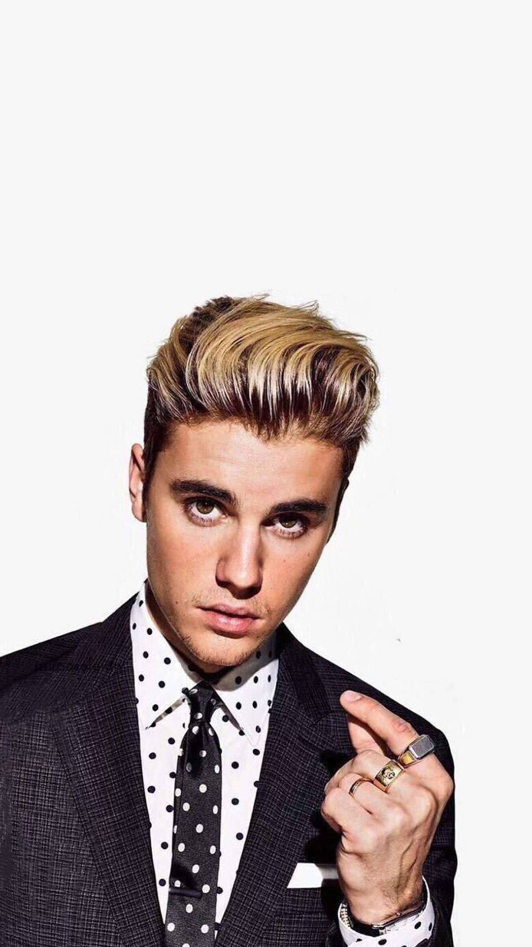 Pop Star Justin Bieber Arrives In A Black Suit. Background