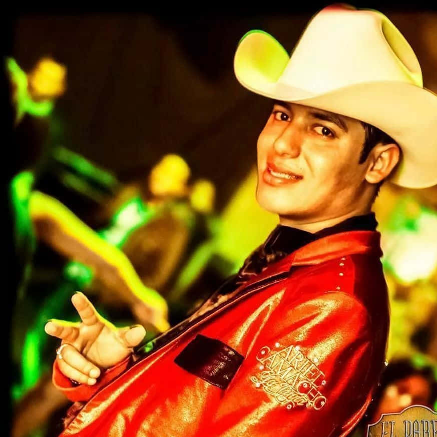 Popular Banda Sinaloense Singer Ariel Camacho Performing For An Audience. Background