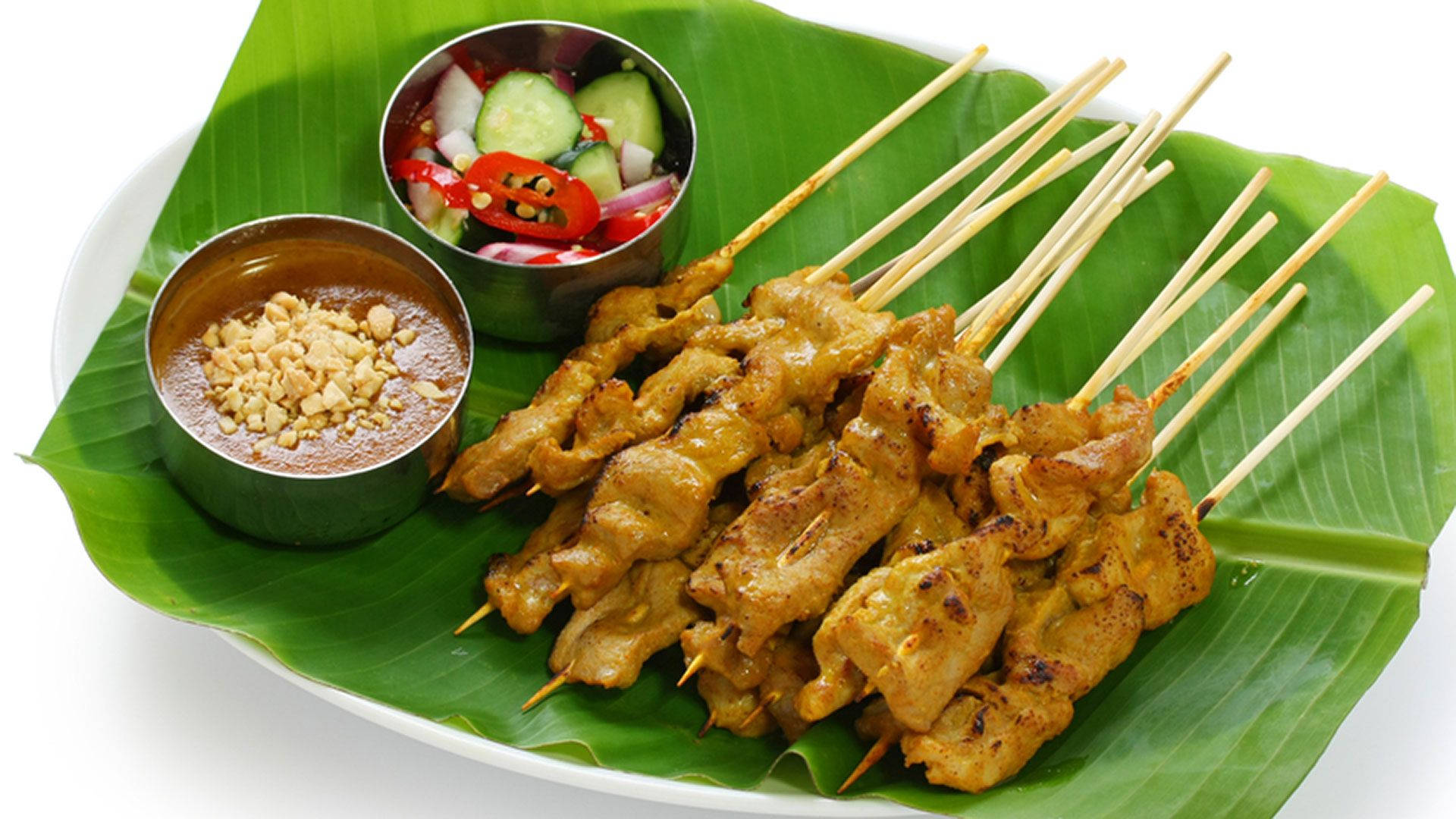 Pork Satay Southeast Asian Dish On Banana Leaf Background