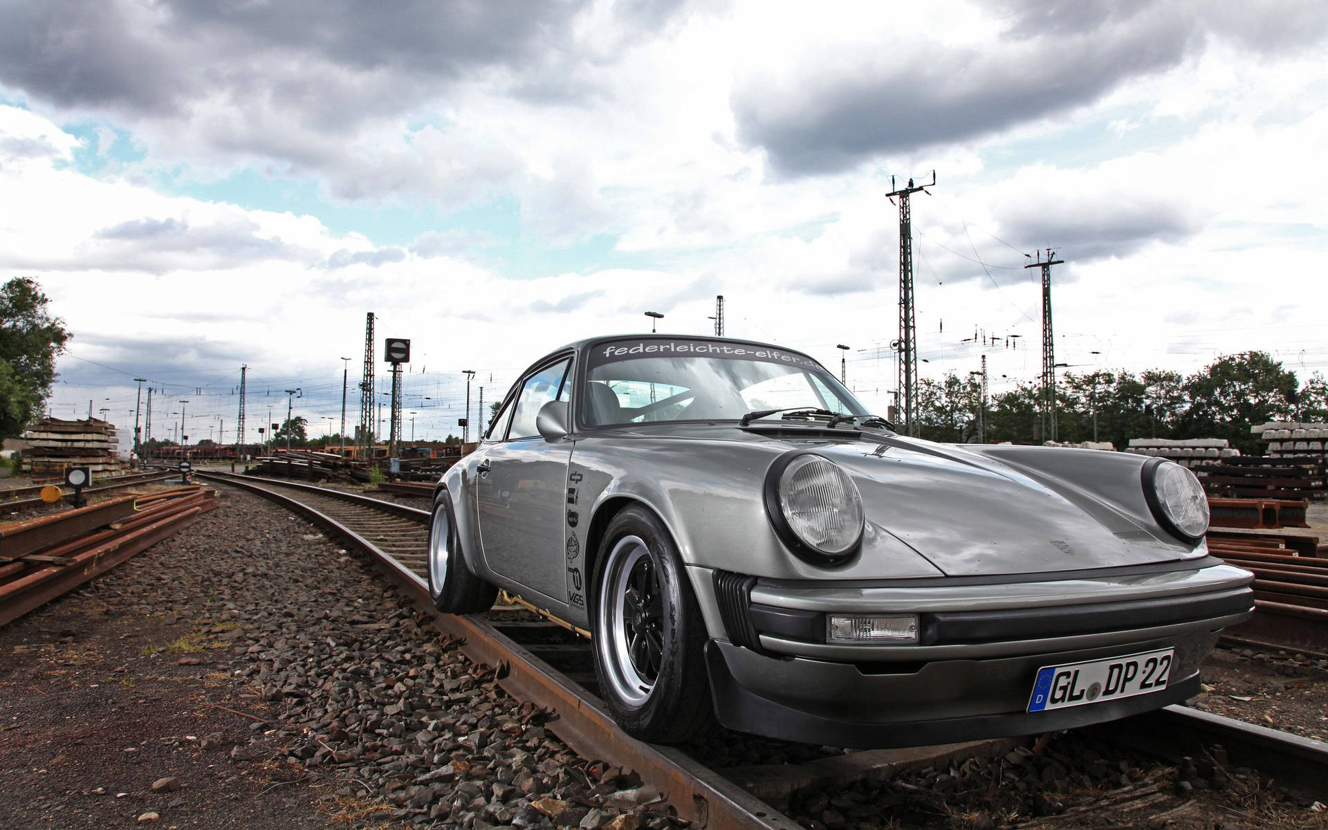 Porsche 911 On Train Tracks Background