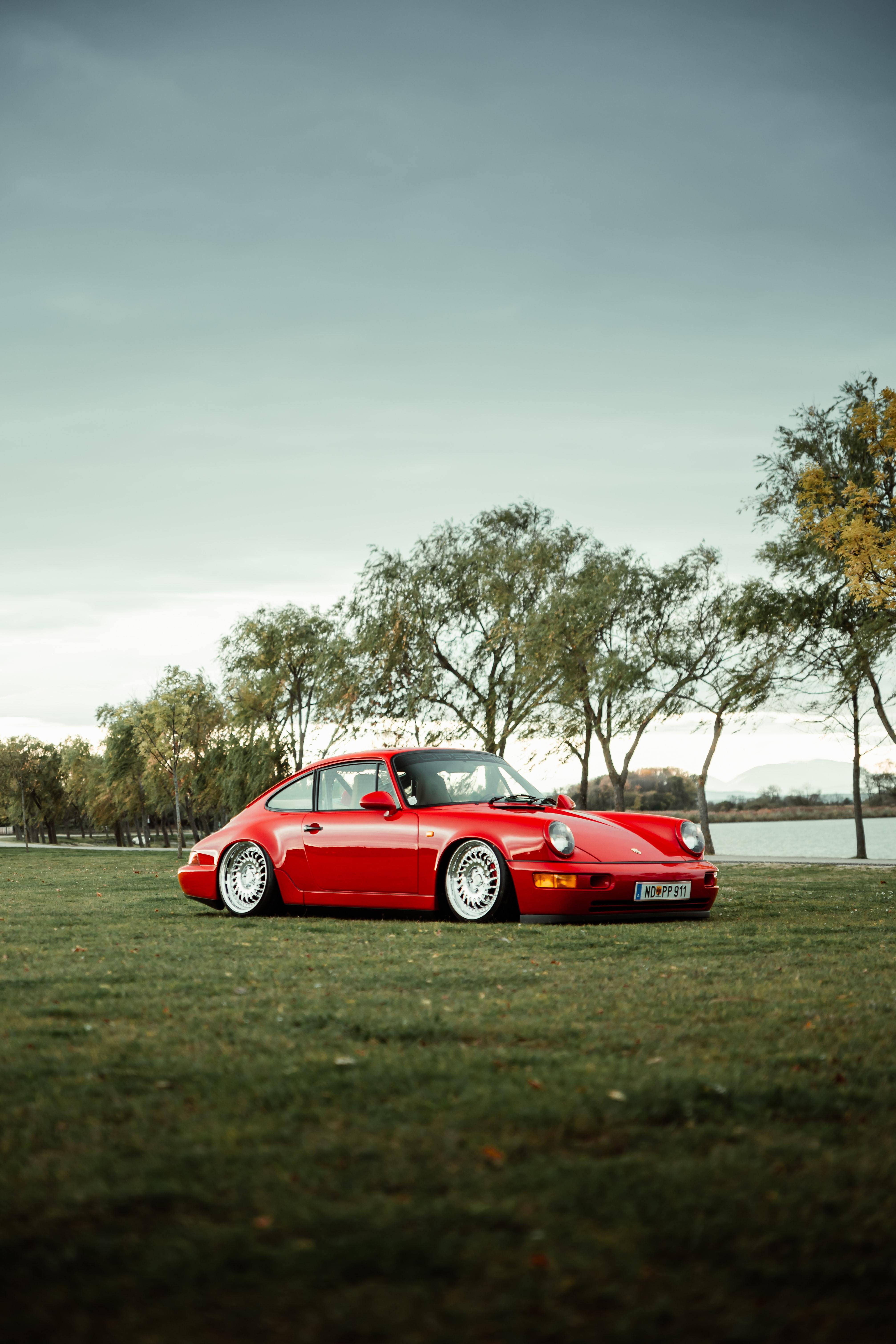 Porsche 911 Parked On The Field Background