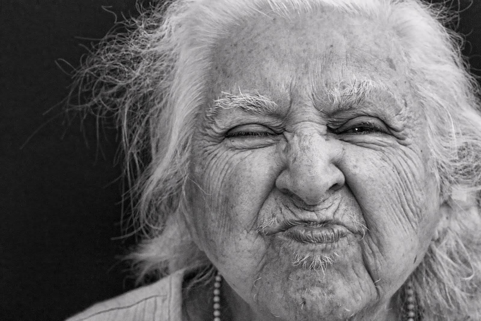 Portrait Of A Radiant Elderly Woman With Pouty Lips Background